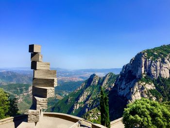 Scenic view of mountains against clear blue sky