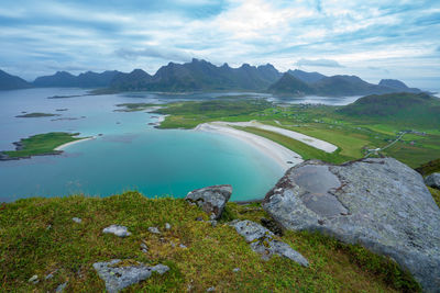 Scenic view of sea and mountains against sky