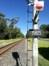 Low angle view of information sign against sky