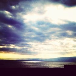 Scenic view of sea against cloudy sky