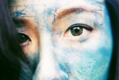 Close-up portrait of young woman with face paint