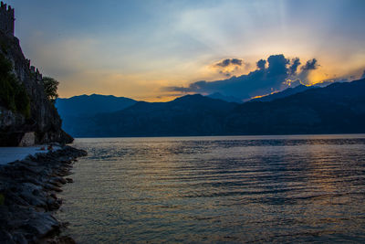 Scenic view of lake against sky at sunset