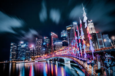 Illuminated buildings against sky at night