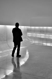 Full length rear view of man standing in water