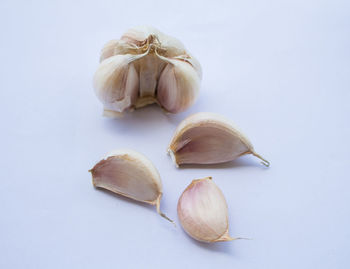 Close-up of garlic on table against white background