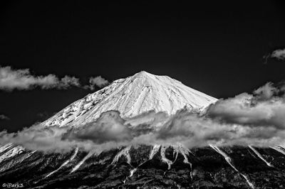 Low angle view of mountain against cloudy sky