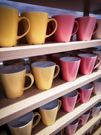 Close-up of coffee cups on shelf