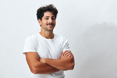 Portrait of young man standing against clear sky