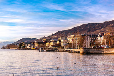 Scenic view of sea and mountains against sky