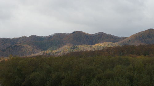 Scenic view of mountains against cloudy sky