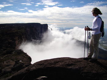 Side view of man standing on mountain