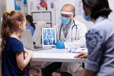 Doctor showing medical x ray at hospital