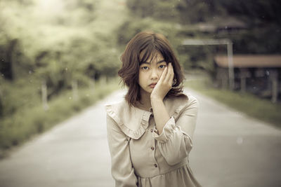 Young woman standing on road