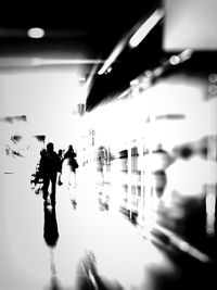 People walking through glass window