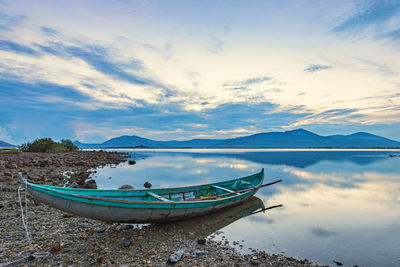 Scenic view of sea and mountains against sky