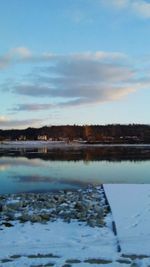 Scenic view of lake against sky during winter