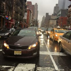 Cars on city street during rainy season