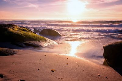 Scenic view of beach against sky during sunset