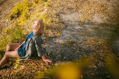 Woman standing by plants during autumn