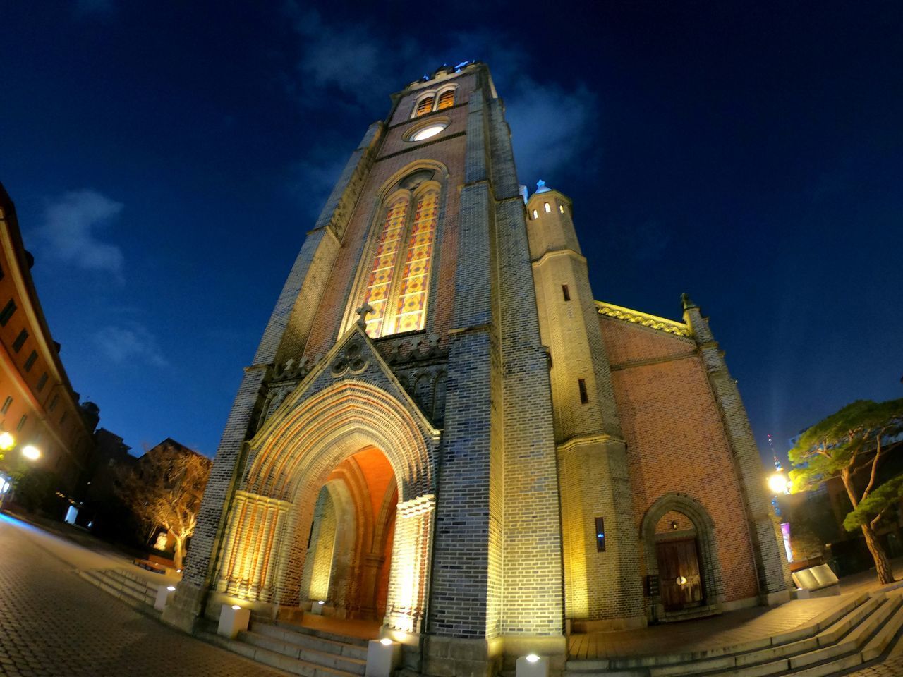 LOW ANGLE VIEW OF ILLUMINATED BUILDING AGAINST SKY