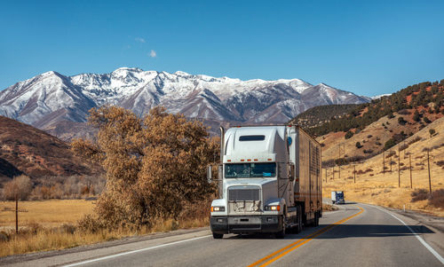 Scenic view of snowcapped mountains against clear blue sky