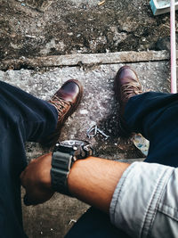 Low section of man wearing shoes standing outdoors