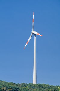 Low angle view of windmill on field against clear sky