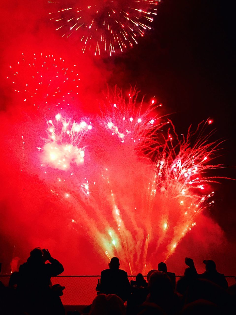 night, firework display, celebration, firework - man made object, red, exploding, arts culture and entertainment, long exposure, event, low angle view, motion, firework, sparks, illuminated, sky, glowing, entertainment, silhouette, blurred motion, celebration event