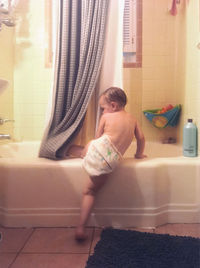 Full length of woman sitting at home