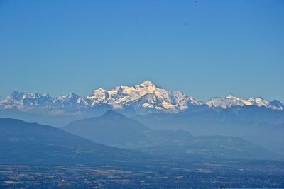 Scenic view of mountains against clear blue sky