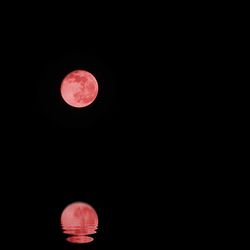 Low angle view of moon against clear sky at night