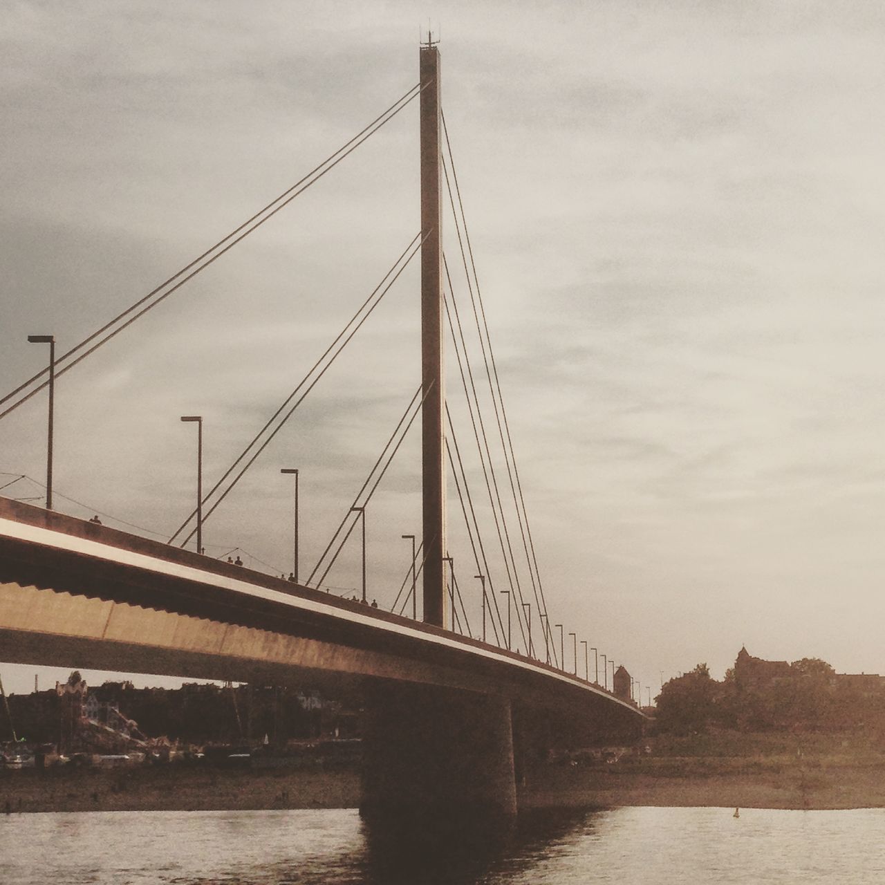 connection, bridge - man made structure, architecture, built structure, engineering, water, river, transportation, sky, suspension bridge, bridge, waterfront, cloud - sky, travel destinations, famous place, travel, low angle view, city, outdoors, cable-stayed bridge