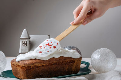 Cropped hand of woman holding cake