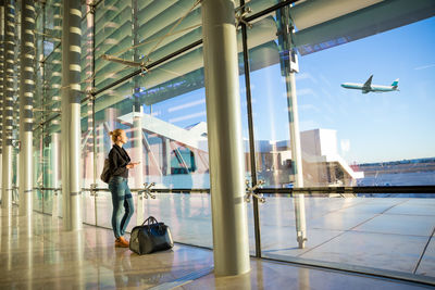 People at airport seen through glass window