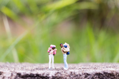 Male and female figurines on footpath