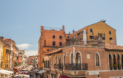 Low angle view of buildings in town against sky