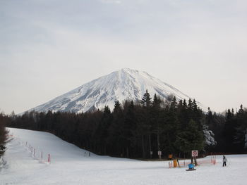 People skiing on snow covered mountain