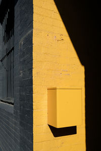 Close-up of yellow shadow on wall