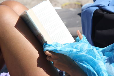 Close-up of woman reading book