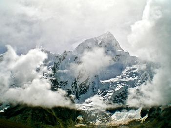 Aerial view of snow covered mountains against sky