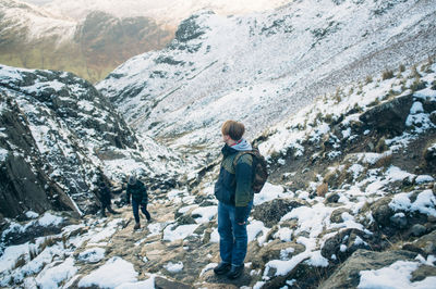 People standing on snow covered landscape