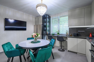 Table and chairs in illuminated room at home