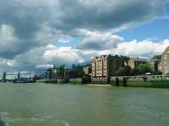 View of cityscape against cloudy sky