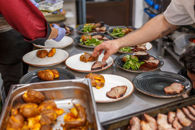 Midsection of man preparing food on table