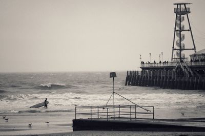 Surfer walking on beach