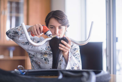 Portrait of young woman holding camera