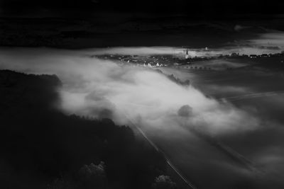 Scenic view of foggy landscape against sky