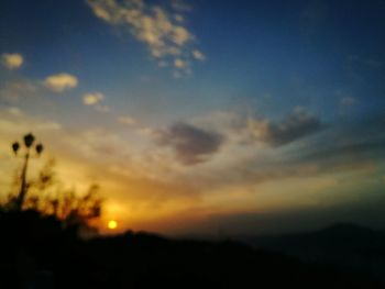 Scenic view of silhouette mountains against sky during sunset