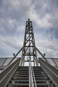 Low angle view of bridge and buildings against sky