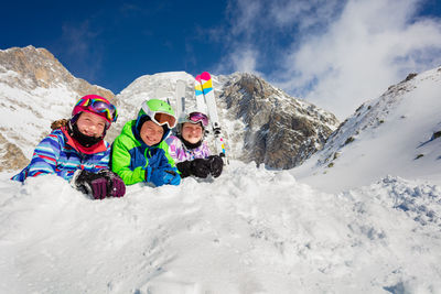 People skiing on snow covered mountain